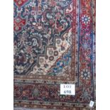A Hamadan rug with central motif on blue red and cream. 225cm x 130cm.