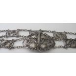 A fine Art Nouveau stylised silver belt with clasp, having nine panels each joined by links.