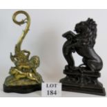 Two nineteenth century door stops, one of cast iron in the form of rampant lion,