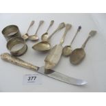 An assortment of silver items, to include two silver napkin rings and various teaspoons.