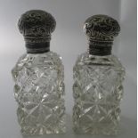 A pair of cut glass rectangular shaped scent bottles with silver screw tops, London 1899.