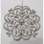 A fine white metal unmarked snowflake pendant, inset with diamonds. The centre diamond approx 0.