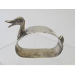 A silver napkin ring in the shape of a duck, Sheffield 1953.