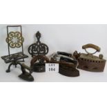 A collection of four old irons including a domed lingerie iron,