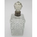 A hobnail cut scent bottle and stopper with silver collar, dated London 1907.