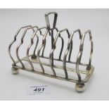 A six sectional silver toast rack on ball feet, Birmingham 1908, approx weight 233 grams/7.