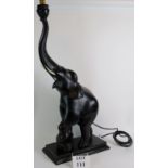 A large Ebonised carved wood elephant lamp with bone tasks and red toe nails! Height: 95cm.