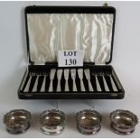 A boxed set of good quality silver plated fish eaters and four small silver plated glass or