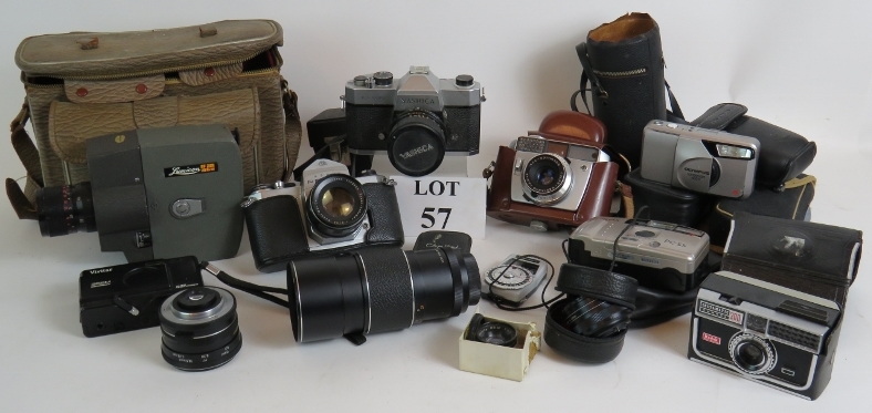 A collection of vintage 35mm cameras and lenses including Yashica, Pentax, Olympus and Vivitar,