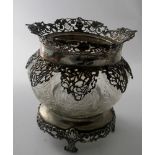 A heavily engraved crystal bowl on a silver base and silver mounted top.