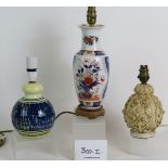 Three table lamps, one decorated in Imari colours, one in cream and blue studio pottery style,