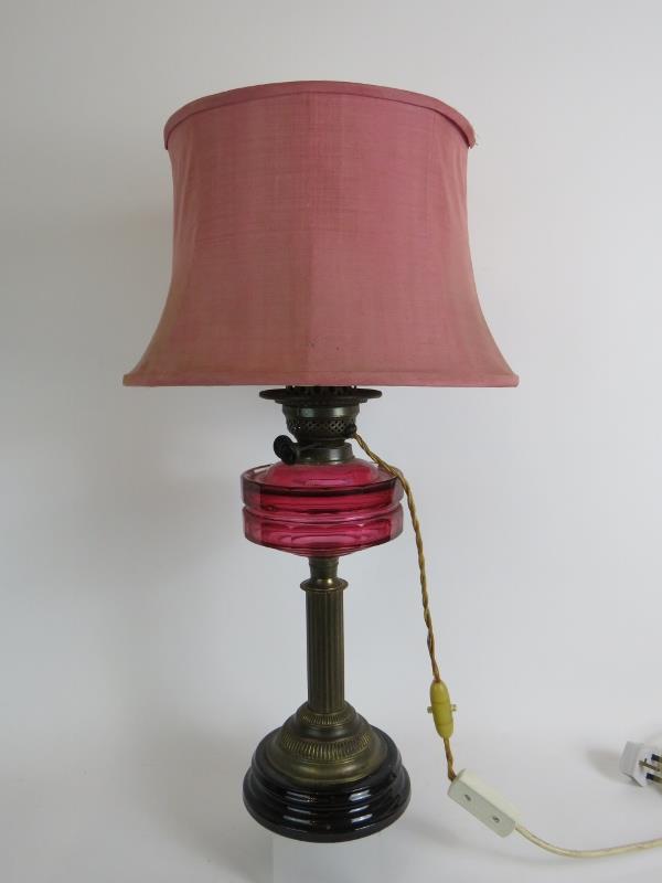 An antique Cranberry glass oil lamp later converted to electricity, with black porcelain base. - Image 4 of 4