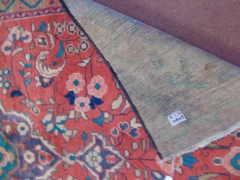 A Hamadan rug on red ground with central motif surrounded by flowers. - Image 4 of 4