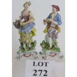A pair of 18th Century style porcelain figures in period dress,