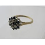 A 9ct gold sapphire and white stone banded, cluster ring, size K.