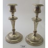 A pair of 925 stamped candlesticks, with bead edge decoration, sconces unmarked, weighted,