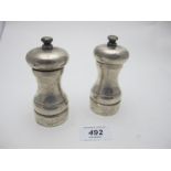 A pair of modern silver 'Peter Piper' pepper and salt grinders, London 1990, some salt damage.