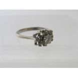 An unusual silver diamond set cluster ring. The centre diamond approx 0.