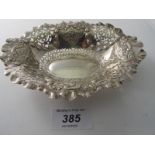 An oval shaped silver bon bon dish with pierced decoration and embossed with panels,