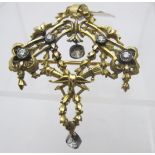 A late 19th century gold and silver tested classical brooch/pendant with six collet set diamonds.