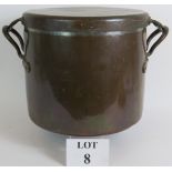 A large antique heavy copper stock pot with fitted lid.