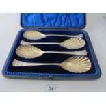 A set of four silver serving spoons with shell bowls and finial's, Sheffield 1900,