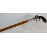 A Malacca walking stick with the handle fashioned from an antique percussion pistol, length: 91cm.