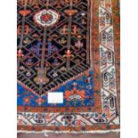 A 20's Malia rug on terracotta field with an in filled cream border, 152cm x 112cm.