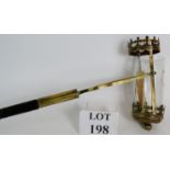 An antique brass porter's or church wardens lamp mounted on a carved Ebony handle.