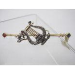 A fine yellow metal bar brooch in the form of a lyre,