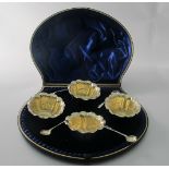 A good quality set of four salts with gilded interiors, London 1897, and four silver salt spoons,