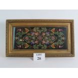 A colourful antique bead work panel with floral motif on black background in a glazed gilt plaster