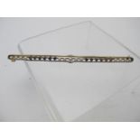 An Art Deco 18ct yellow and white gold long bar brooch set with seed pearls.