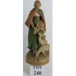 A Bohemian Royal Dux figure of a female goat herd and two goats. Overall height: 41cm.