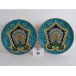 A pair of 19th Century Persian enamelled pottery peacock chargers,