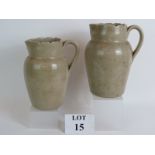 Two rustic stoneware dairy jugs, Early 20th Century, both with incised marks and fluted rims.