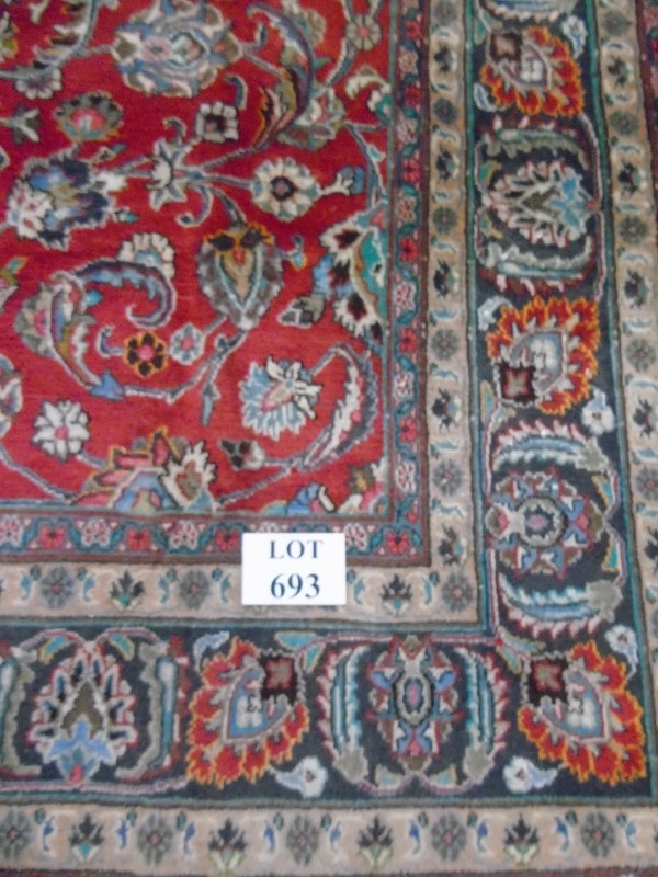 A large Persian carpet on red ground. Possibly Kashan. 2.95m x 2.00m.