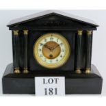 A Victorian black slate mantel clock in Palladian style with gilt and enamel dial. Height 28cm.