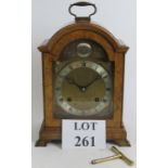 An Elliott of London burr walnut bracket clock with three gong half hour strike, complete with key.
