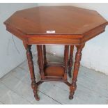 An octagonal mahogany centre table with turned upright supports over a lower shelf having a gallery