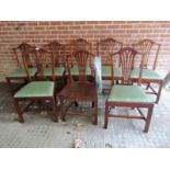 A harlequin set of eight Georgian oak framed dining chairs with green upholstered drop in pad seats.