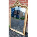 A decorative 19th Century gilt carved wall mirror with bevelled glass.