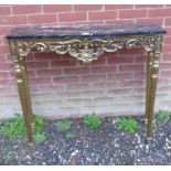 A decorative 20th Century console table with a black marble top over a gilt base.