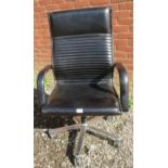 A contemporary ribbed black leather Wilkhan's ergonomic desk chair with a chrome swivel base.