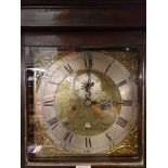 A 19th century oak cased eight day longcase clock with a square brass dial having brass filigree