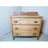 A 20th Century oak chest of three long drawers beneath a raised gallery rail to top.