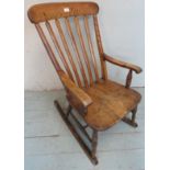A 19th Century oak and elm rocking Windsor armchair with turned supports.