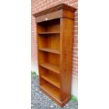 A 20th Century mahogany tall open bookcase with adjustable shelves beneath a very decorative inlaid