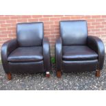 A pair of 20th Century brown leather lounge armchairs in good condition.