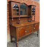 A large 19th century oak sideboard with a central mirror to top flanked either side by glazed
